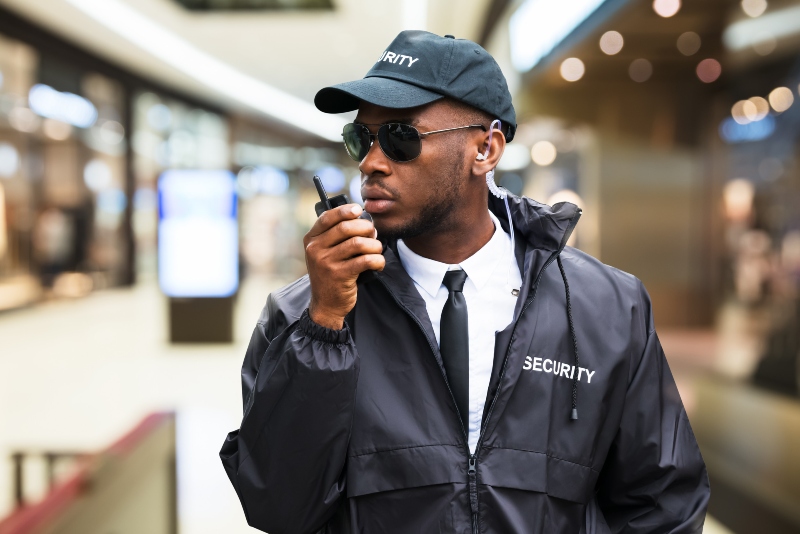 security guard using walkie talkie in shopping mall